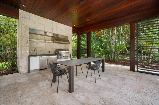 a outdoor dining space with furniture and outdoor view