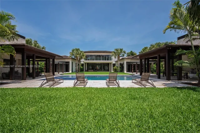 a view of a house with a big yard and sitting area