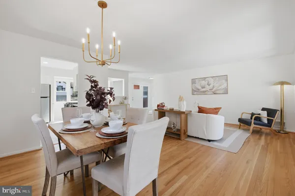 a view of a dining room with furniture wooden floor and chandelier