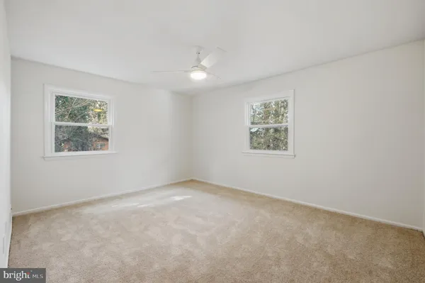 an empty room with windows and closet