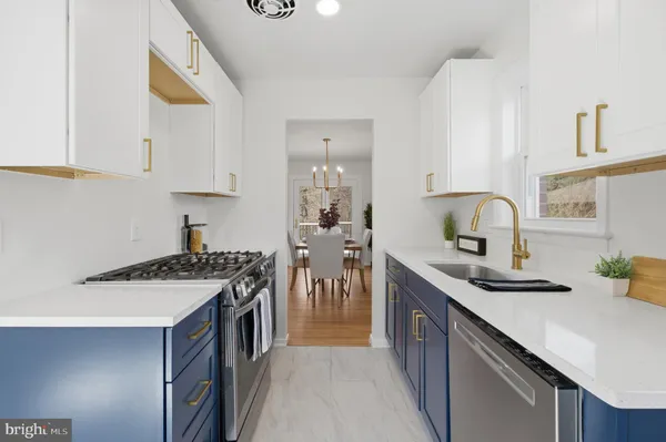 a kitchen with stainless steel appliances granite countertop a sink stove and cabinets