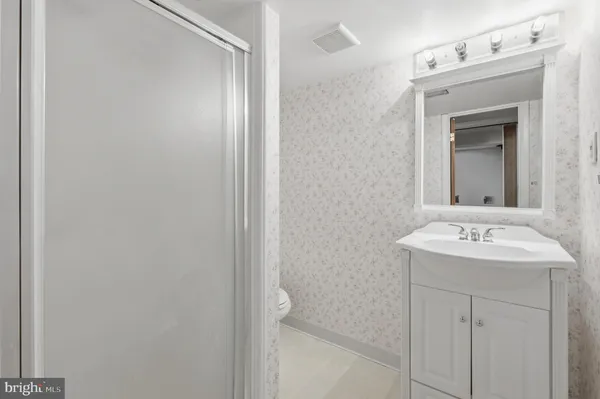 a view of house with a yard and potted plants