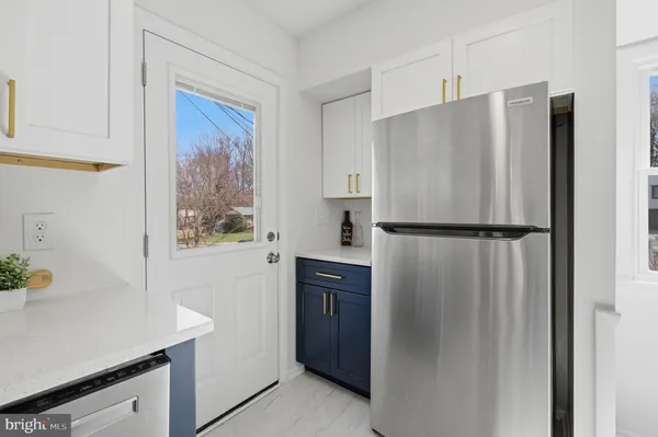 a kitchen with stainless steel appliances a refrigerator and a sink