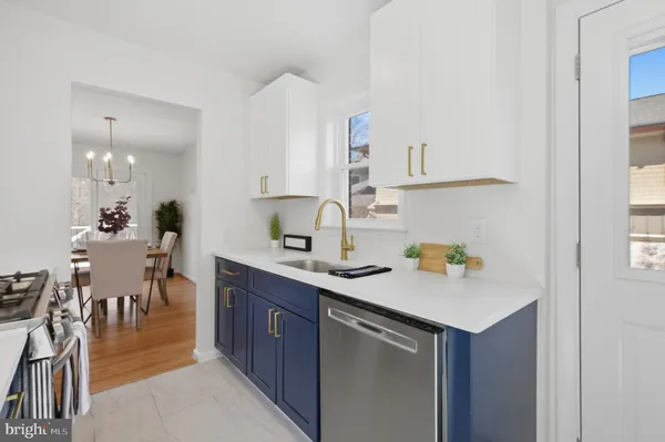 a kitchen with a sink cabinets and dining table