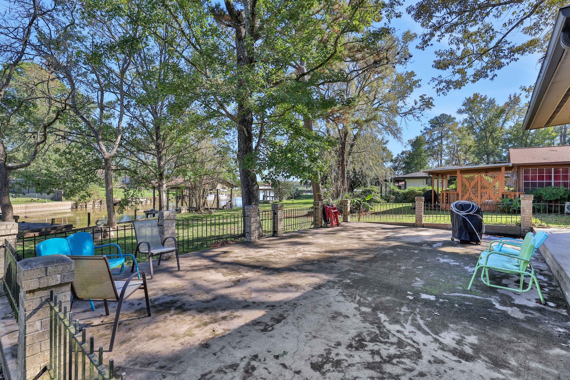 148 South Oak Bluff Street Trinity, TX 75862 - Photo 39 of 46 a view of a backyard with table and chairs and a large tree