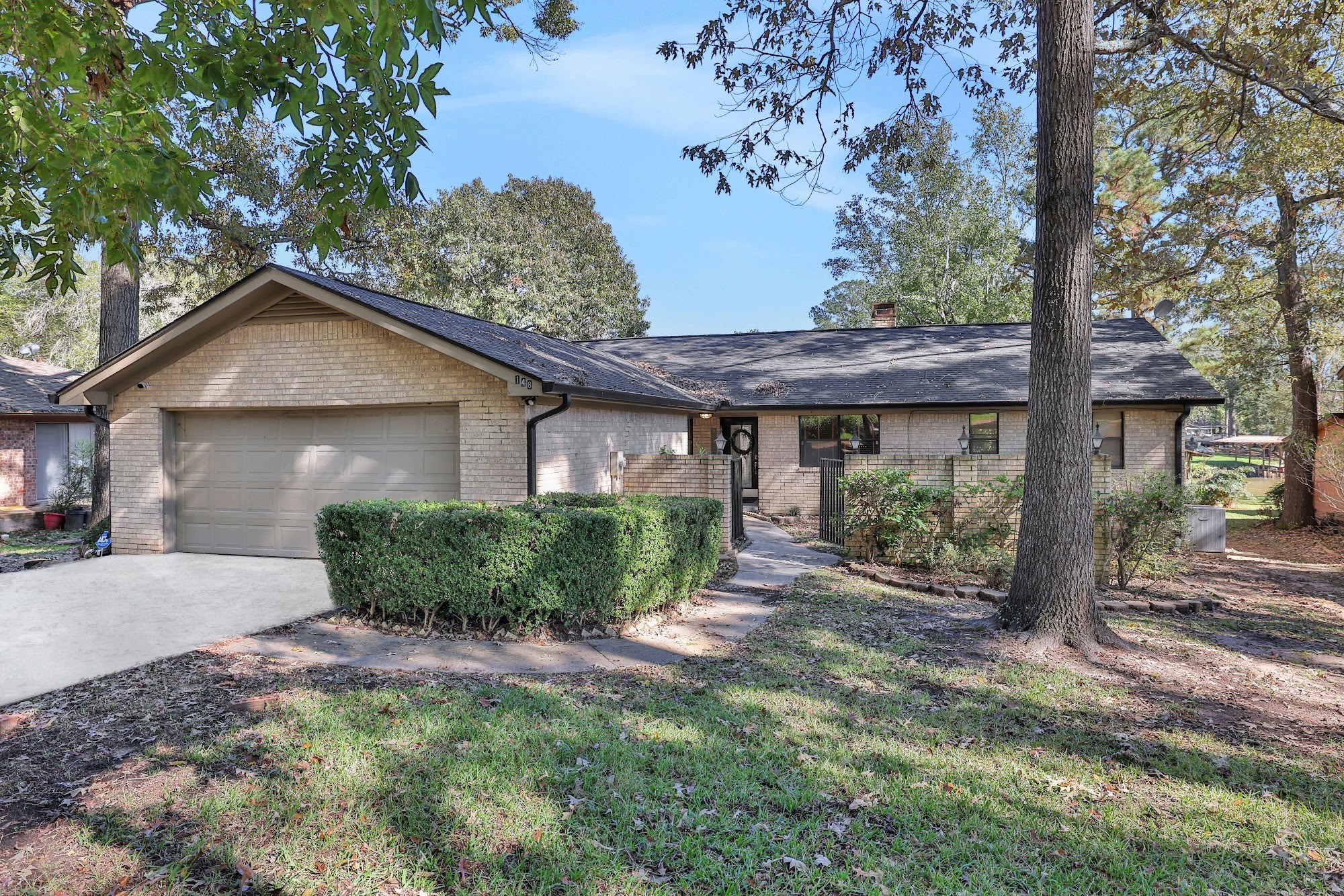 148 South Oak Bluff Street Trinity, TX 75862 - Photo 5 of 46 a front view of a house with a garden