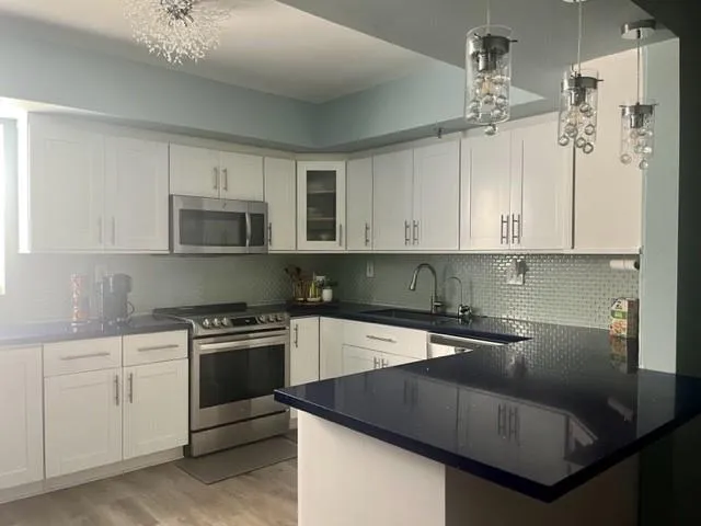 a kitchen with a sink cabinets and appliances