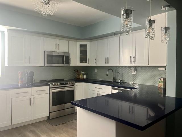 a kitchen with a sink cabinets and appliances