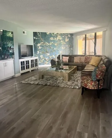 a living room with furniture and a floor to ceiling window
