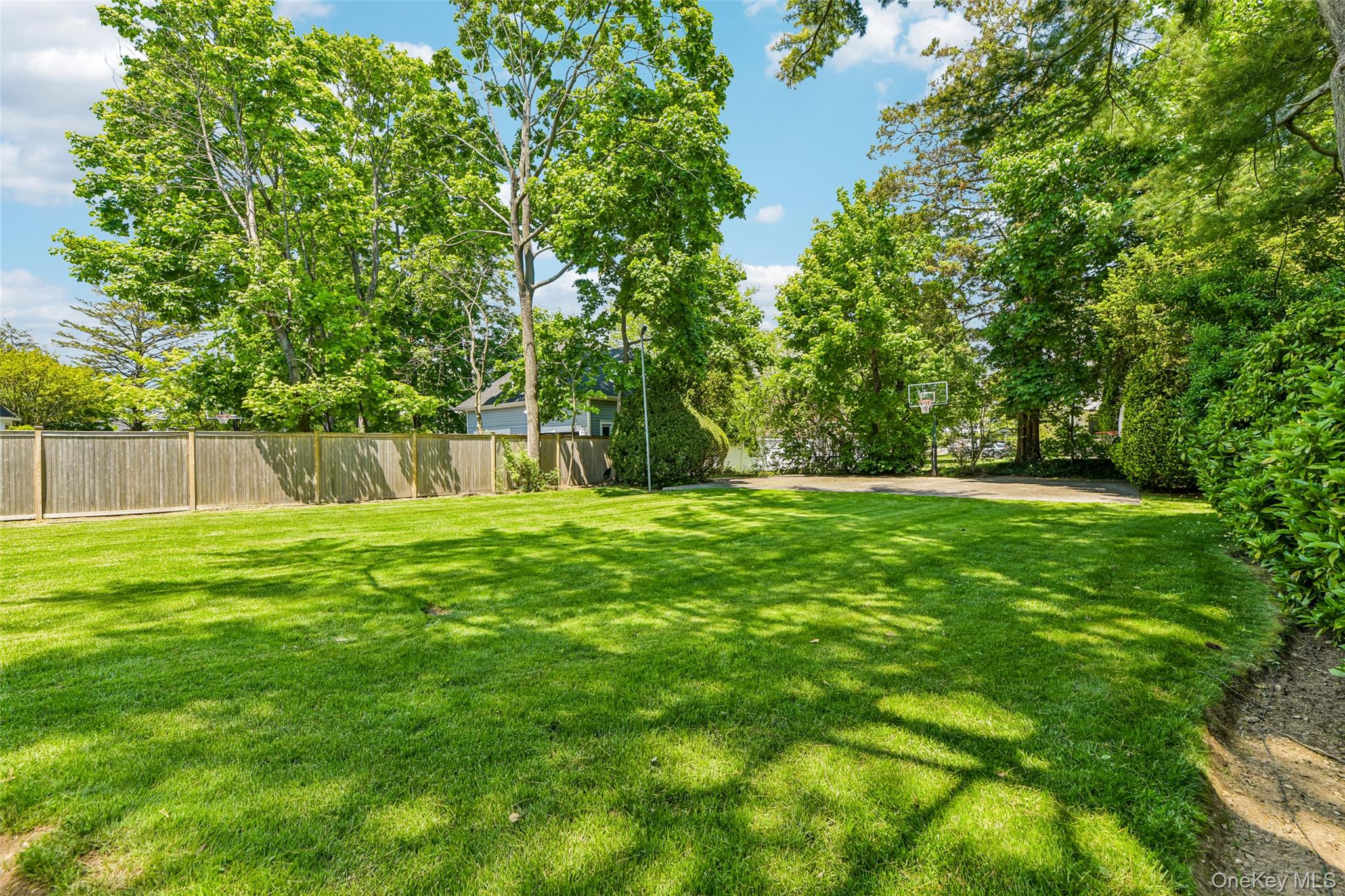 100 Hewlett Neck Road Woodmere, NY 11598 - Photo 37 of 45 a view of a yard with a tree