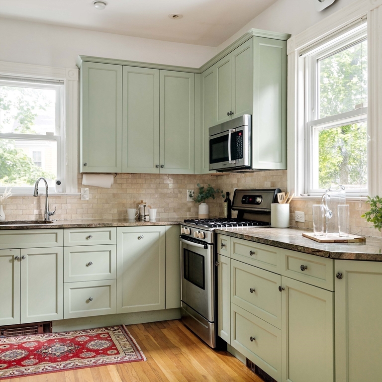 52 Walter Street Boston, MA 02131 - Photo 13 of 31 a kitchen with stainless steel appliances granite countertop a sink stove and microwave