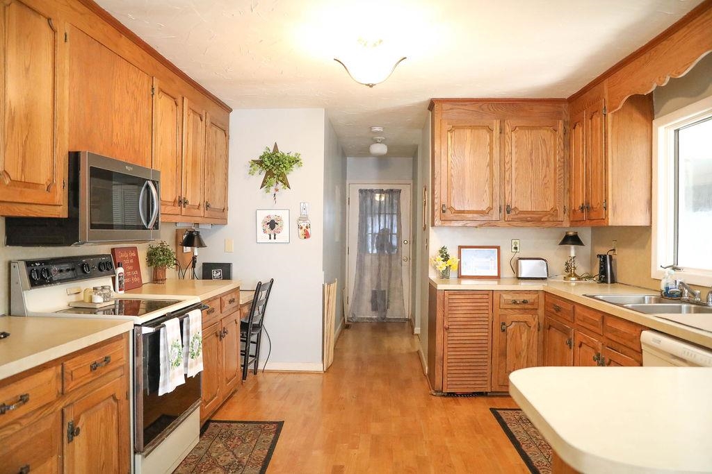 1401 Ladd Road Waynesboro, VA 22980 - Photo 15 of 53 a kitchen with stainless steel appliances a sink a stove a refrigerator cabinets and a window