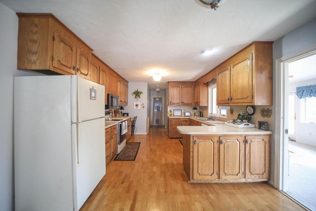1401 Ladd Road Waynesboro, VA 22980 - Photo 16 of 53 a kitchen with a refrigerator a sink and dishwasher with wooden floor