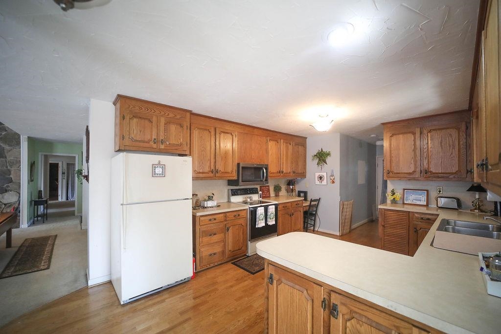1401 Ladd Road Waynesboro, VA 22980 - Photo 19 of 53 a kitchen with a sink a refrigerator and a stove top oven