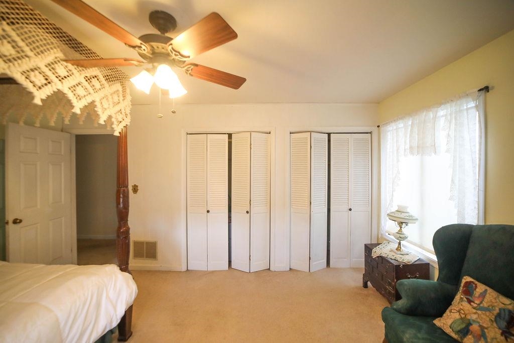 1401 Ladd Road Waynesboro, VA 22980 - Photo 31 of 53 a bedroom with a bed and a chandelier