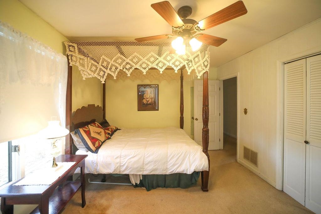 1401 Ladd Road Waynesboro, VA 22980 - Photo 32 of 53 a spacious bedroom with a bed and a chandelier