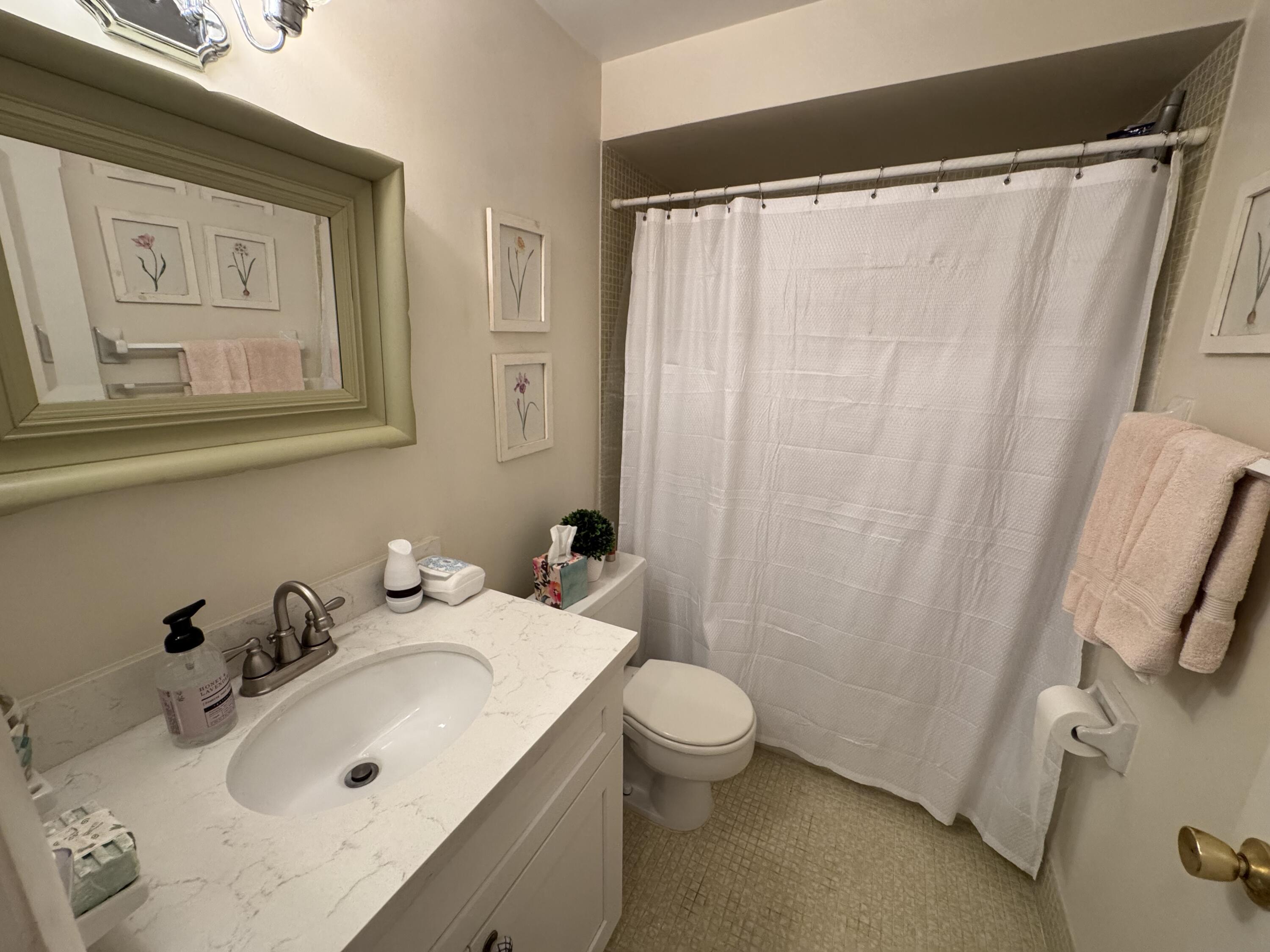 5505 North Ocean Boulevard, Unit 12103 Ocean Ridge, FL 33435 - Photo 13 of 28 a bathroom with a sink and a mirror