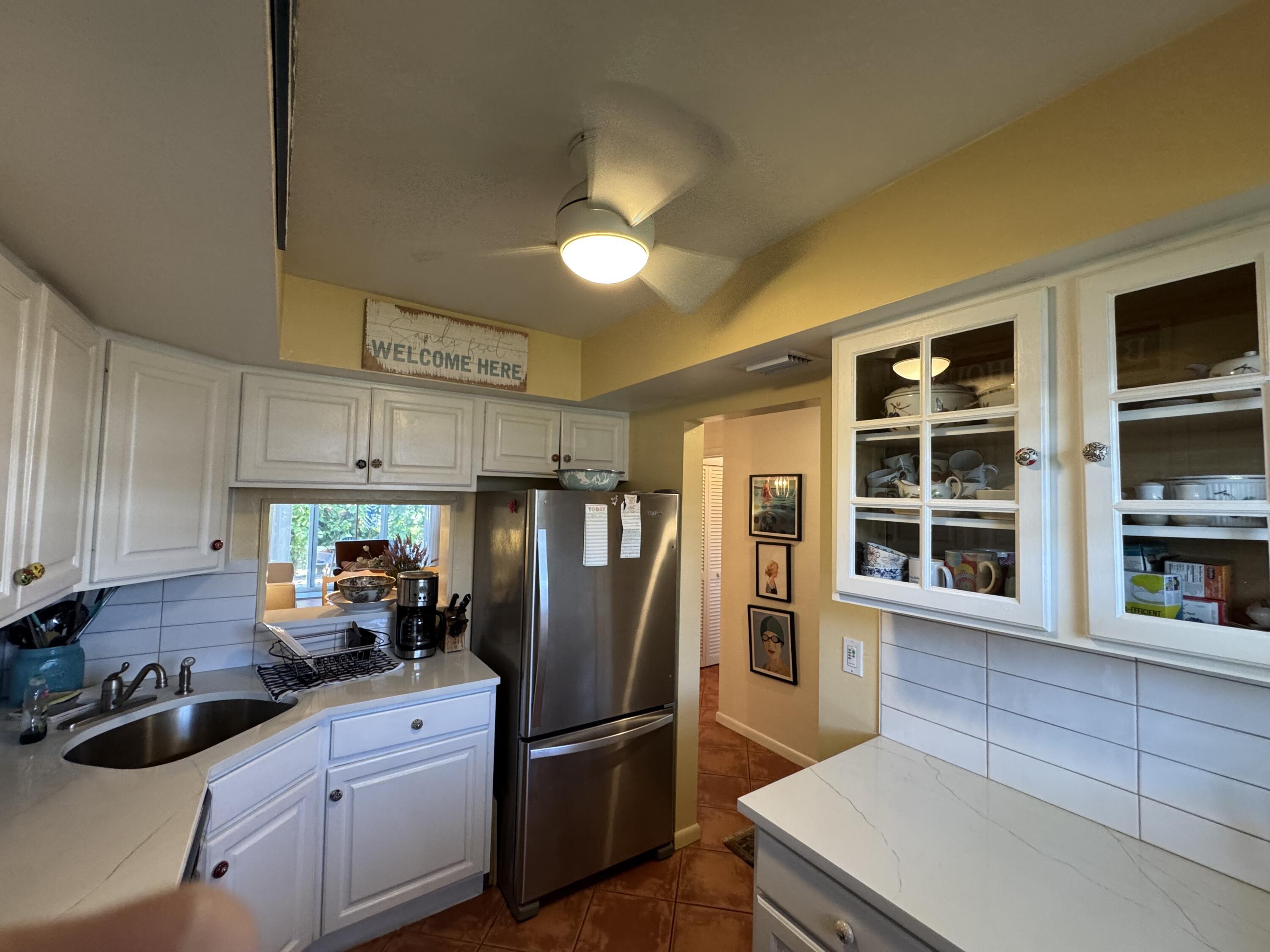 5505 North Ocean Boulevard, Unit 12103 Ocean Ridge, FL 33435 - Photo 14 of 28 a kitchen with stainless steel appliances granite countertop a refrigerator a sink a stove and a microwave oven
