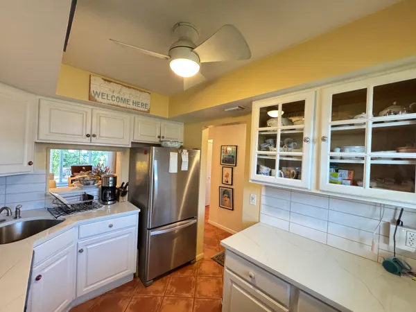 a kitchen with stainless steel appliances a refrigerator and a sink
