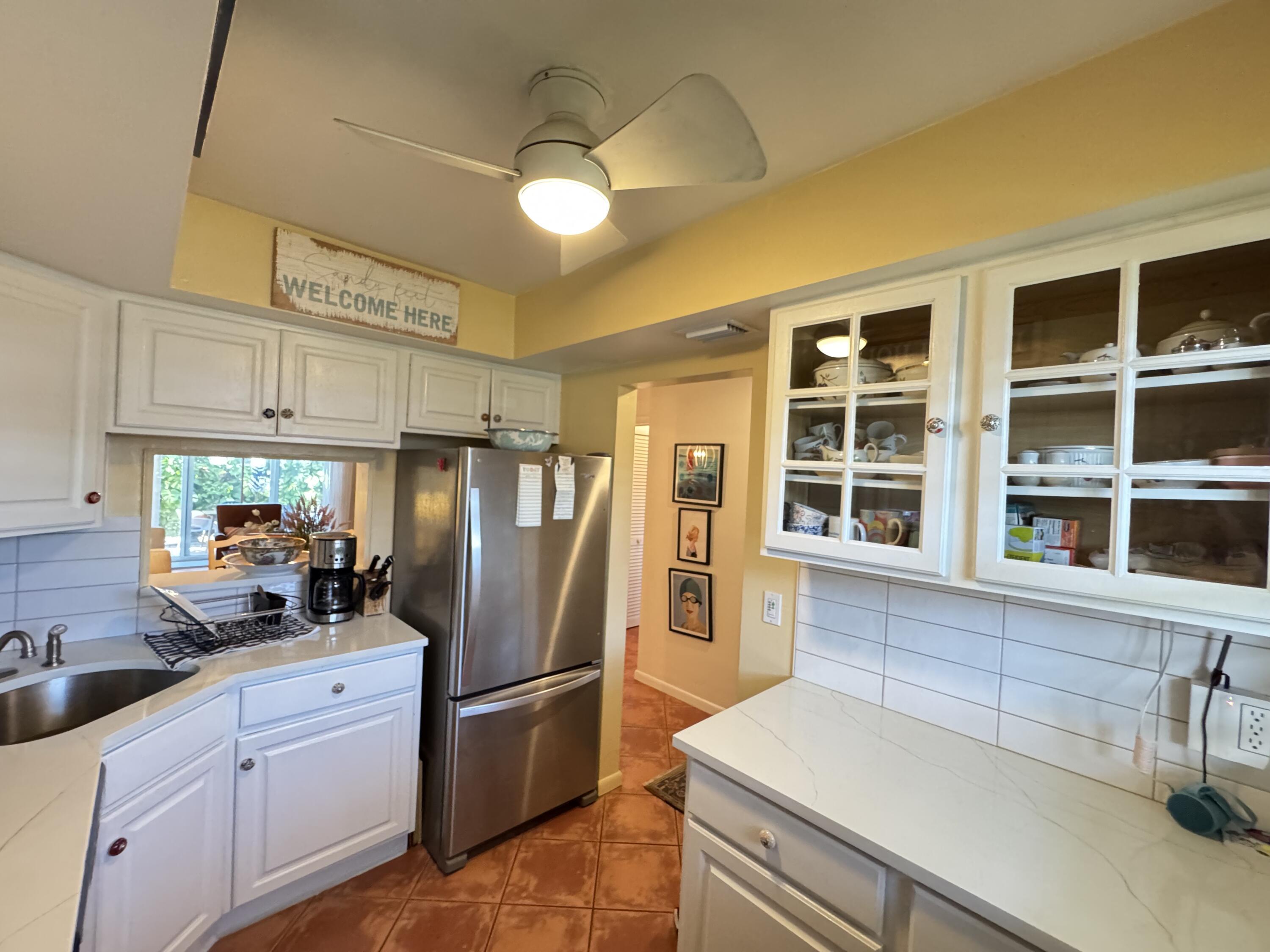 5505 North Ocean Boulevard, Unit 12103 Ocean Ridge, FL 33435 - Photo 15 of 28 a kitchen with stainless steel appliances a refrigerator and a sink