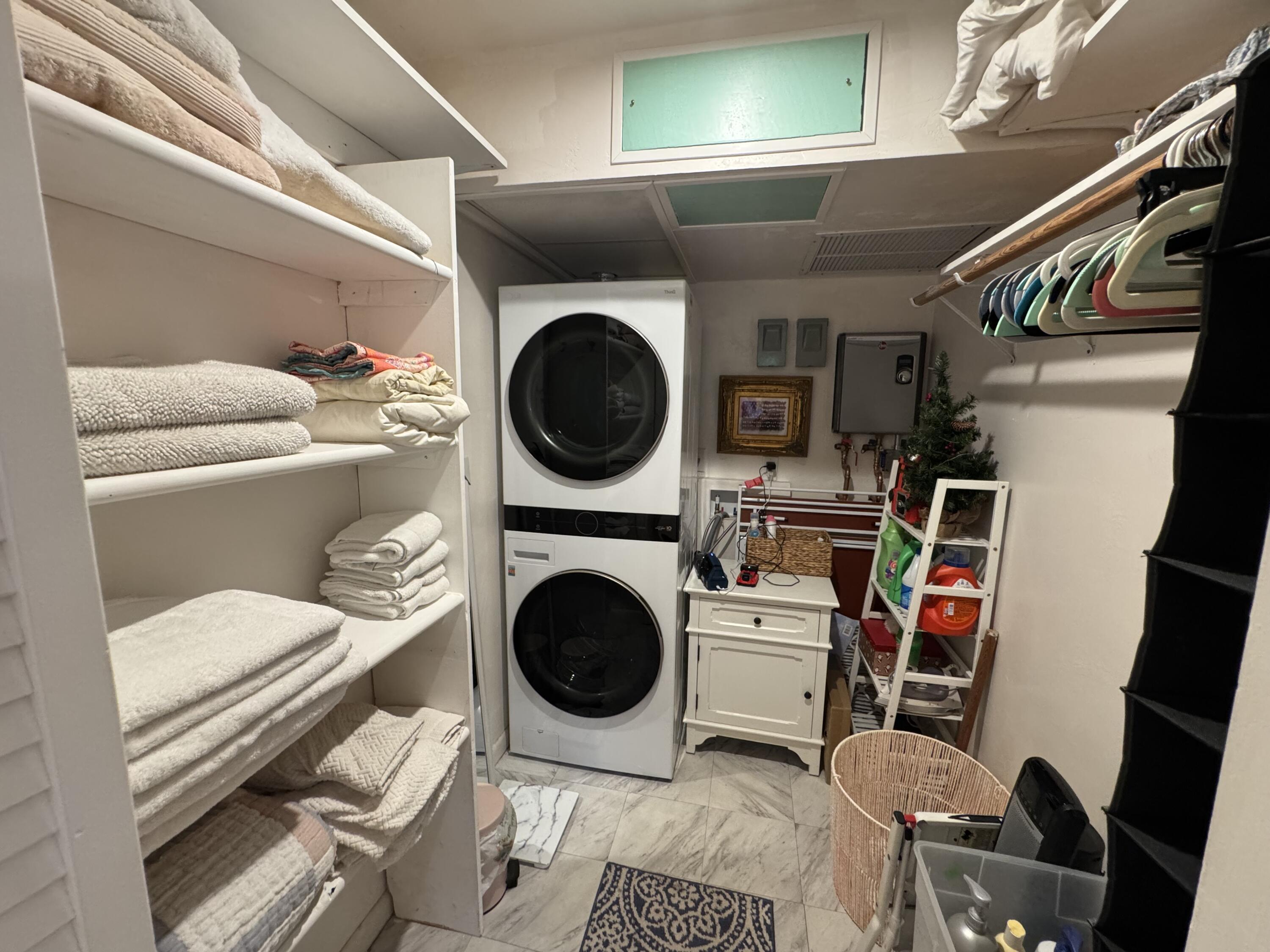 5505 North Ocean Boulevard, Unit 12103 Ocean Ridge, FL 33435 - Photo 18 of 28 a utility room with dryer washer and a view of living room