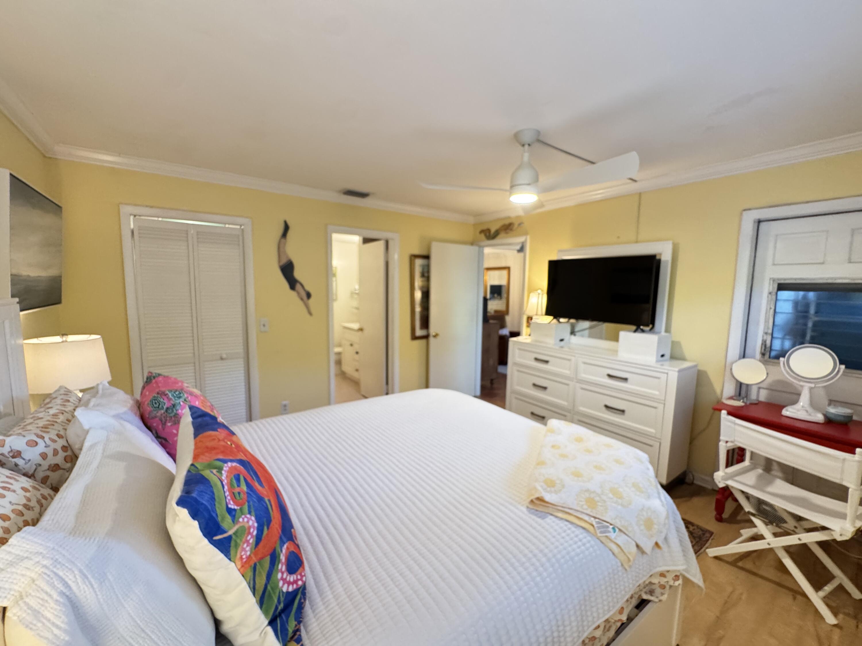 5505 North Ocean Boulevard, Unit 12103 Ocean Ridge, FL 33435 - Photo 20 of 28 a bedroom with a bed and a flat screen tv