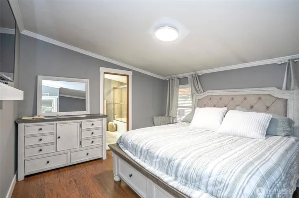 a bedroom with a large bed and a dresser