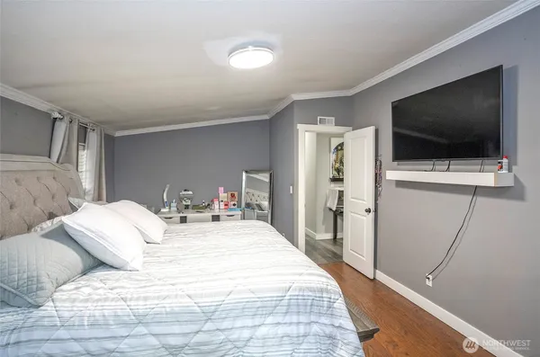 a bedroom with a flat screen tv and a bed