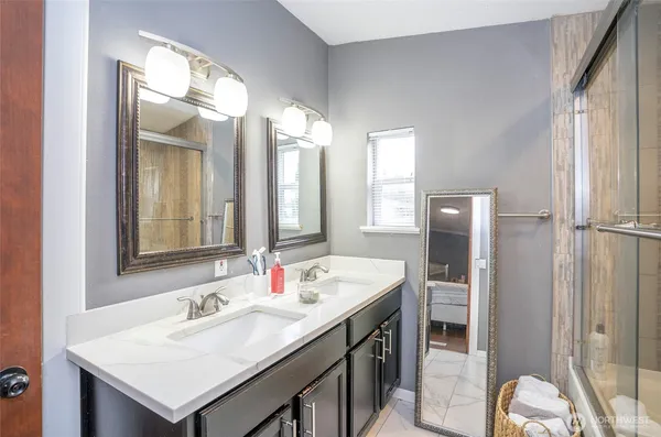 a bathroom with a sink double vanity and a mirror