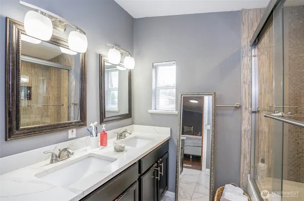 a bathroom with a double vanity sink mirror and double