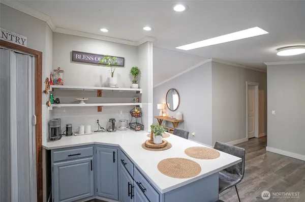 a kitchen with a sink a stove and cabinets