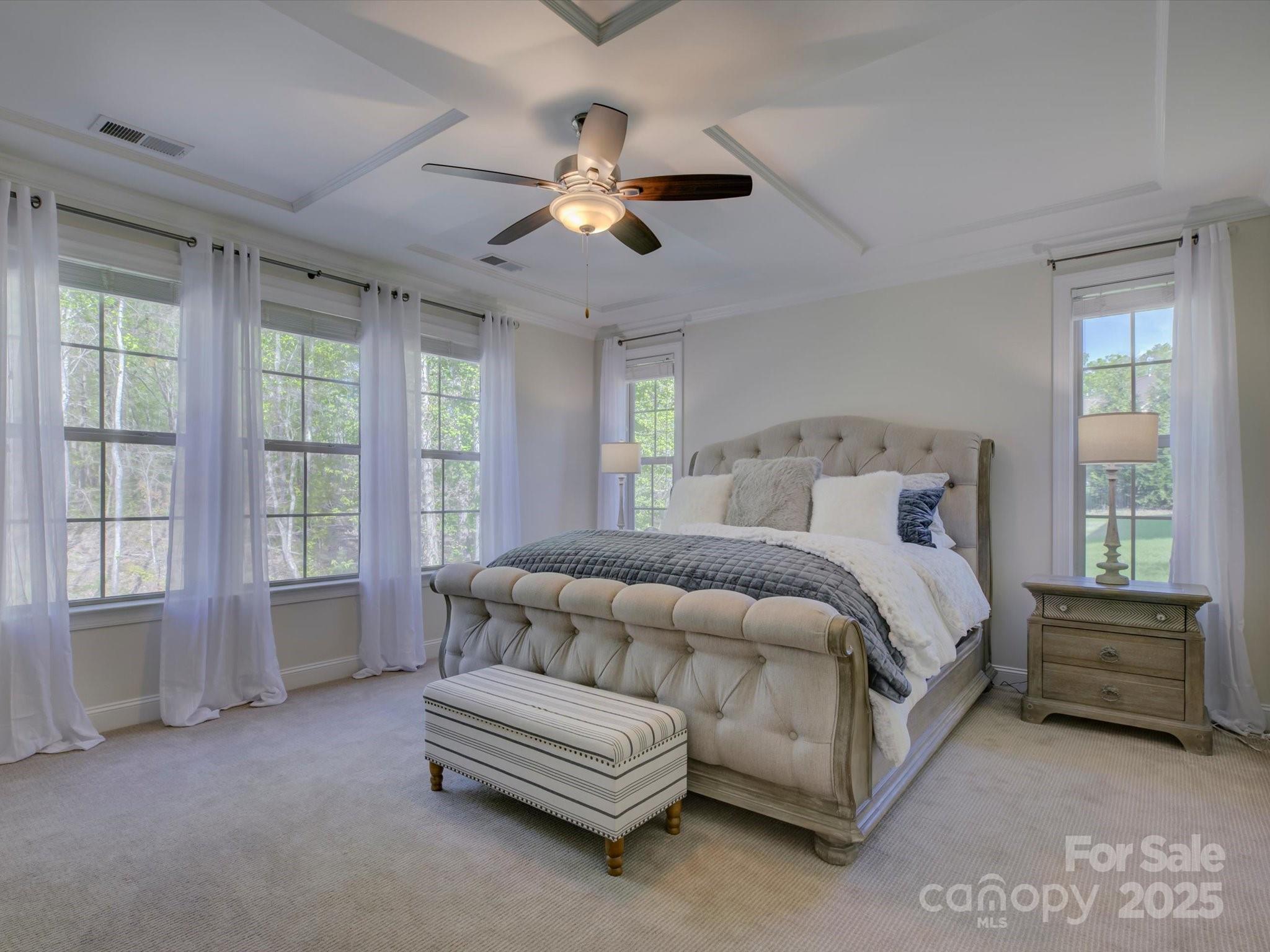 712 Chase Court Fort Mill, SC 29708 - Photo 20 of 48 a bedroom with a large bed and a chandelier fan