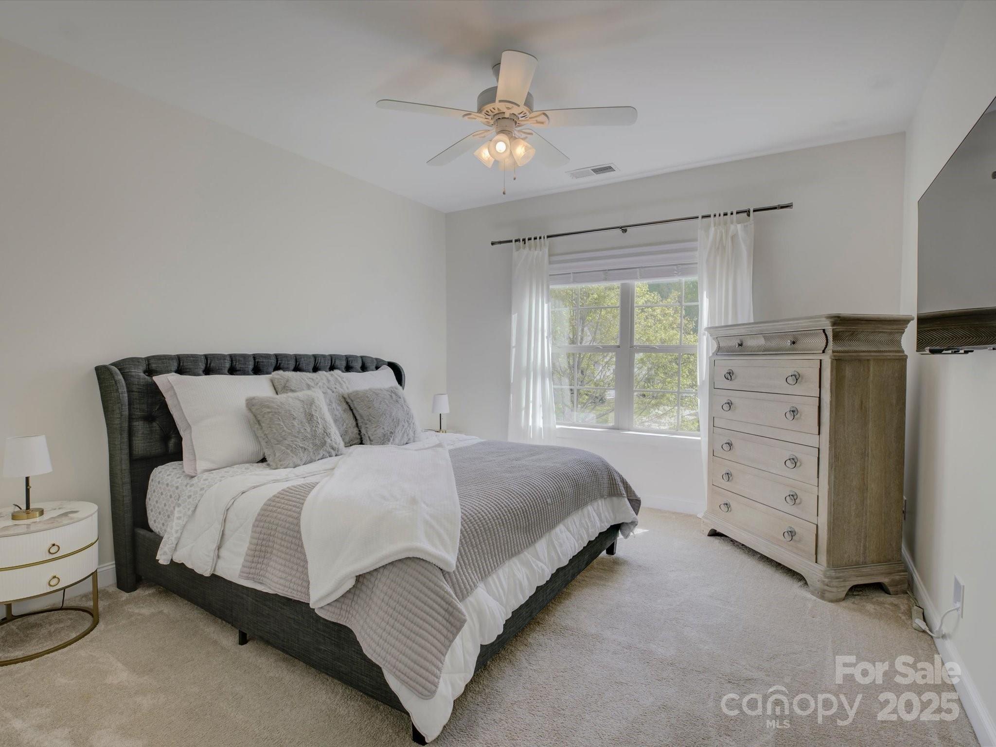 712 Chase Court Fort Mill, SC 29708 - Photo 28 of 48 a spacious bedroom with a bed and a window