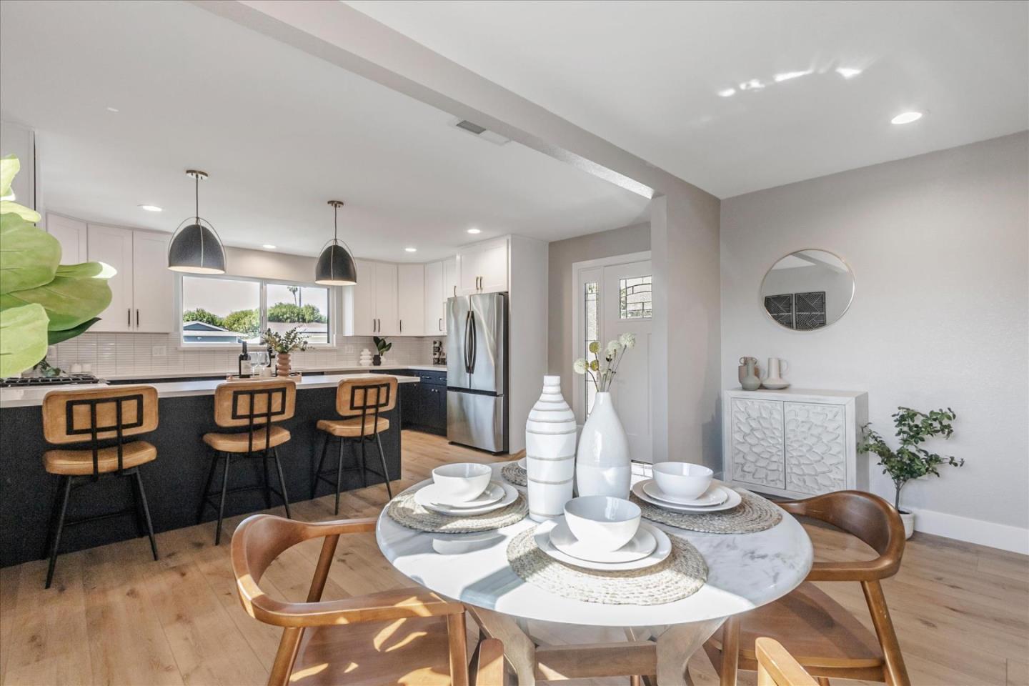 2575 Trimble Road San Jose, CA 95132 - Photo 12 of 74 a kitchen with stainless steel appliances kitchen island granite countertop a dining table chairs and view of living room