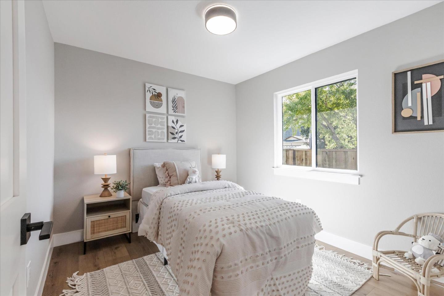 2575 Trimble Road San Jose, CA 95132 - Photo 21 of 74 a bedroom with a bed and wooden floor
