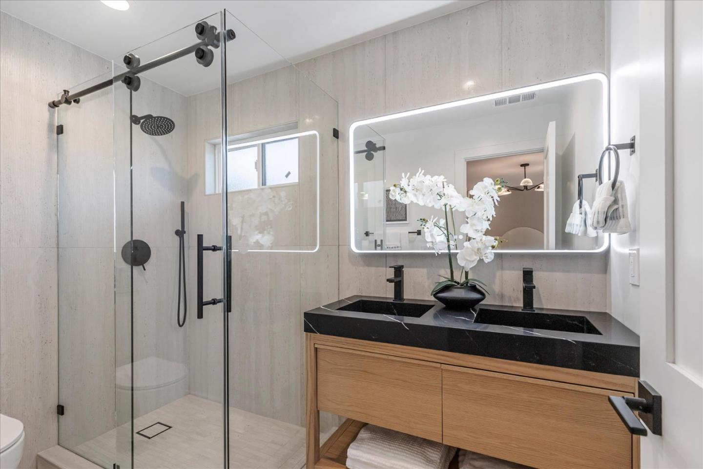 2575 Trimble Road San Jose, CA 95132 - Photo 28 of 74 a bathroom with a granite countertop sink a mirror and shower