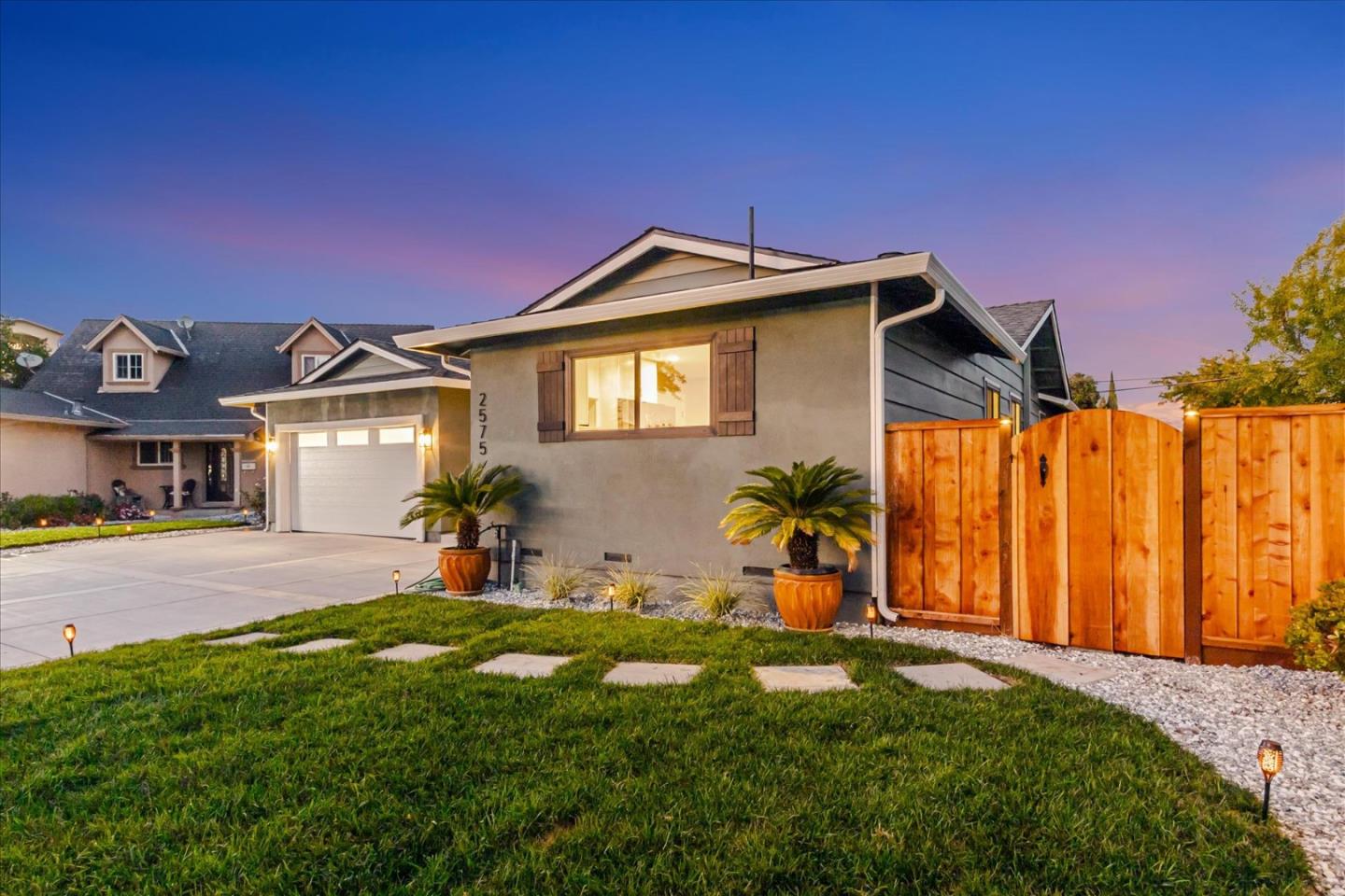 2575 Trimble Road San Jose, CA 95132 - Photo 47 of 74 a front view of a house with a yard and potted plants
