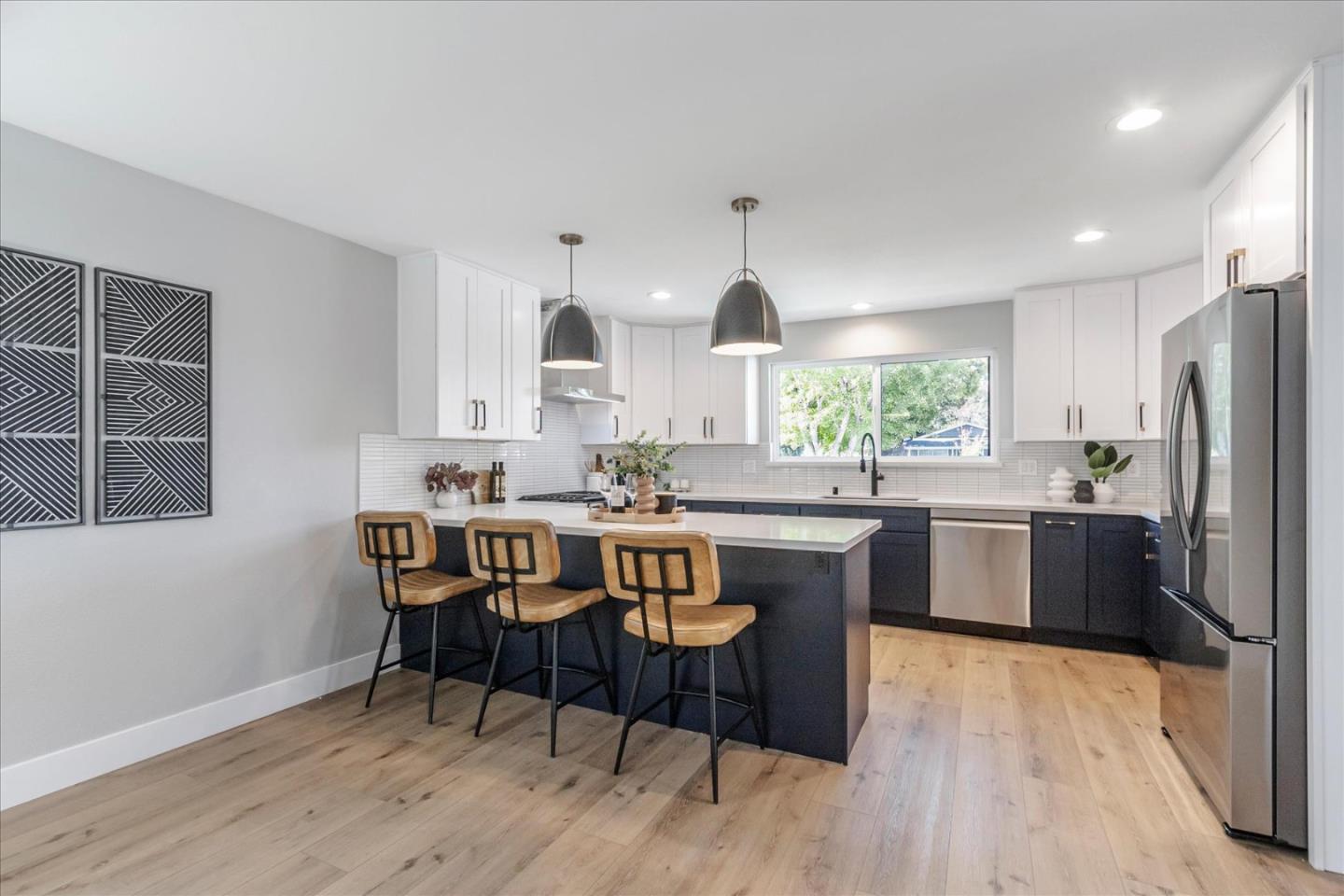 2575 Trimble Road San Jose, CA 95132 - Photo 7 of 74 a kitchen with stainless steel appliances granite countertop a kitchen island hardwood floor sink stove dining table and chairs