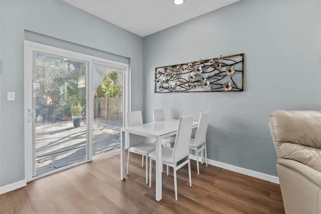 a view of a dining room with furniture wooden floor and front door