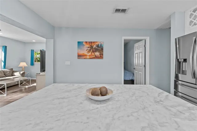 a bedroom with a bed and a painting on the wall