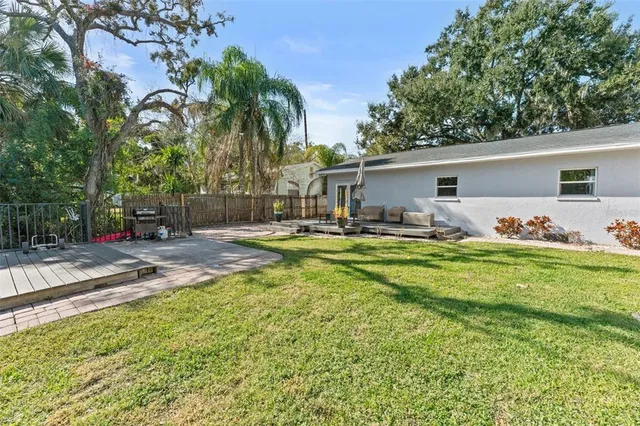 a row of palm trees sitting in front of a house
