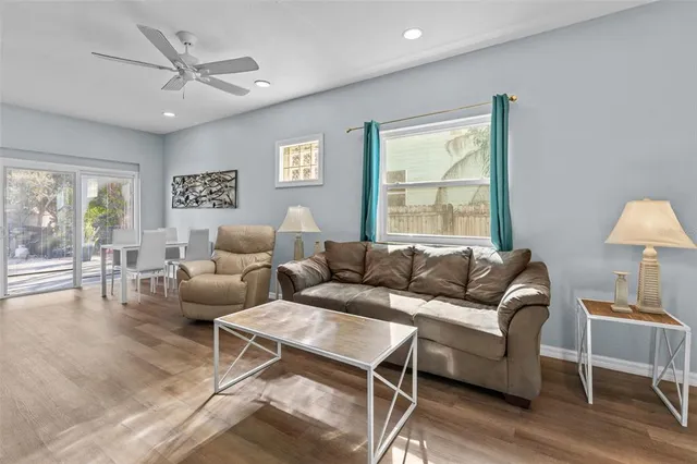 a living room with furniture a large window and a table