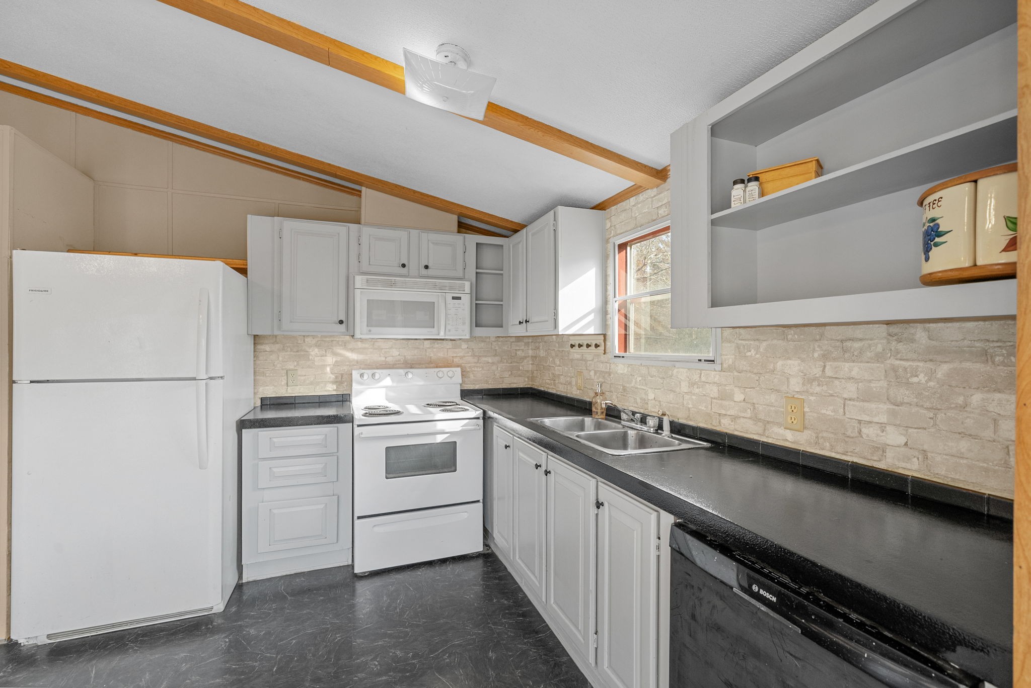 1196 Pickle Knight Road Joelton, TN 37080 - Photo 11 of 32 a kitchen with stainless steel appliances granite countertop a sink stove and refrigerator