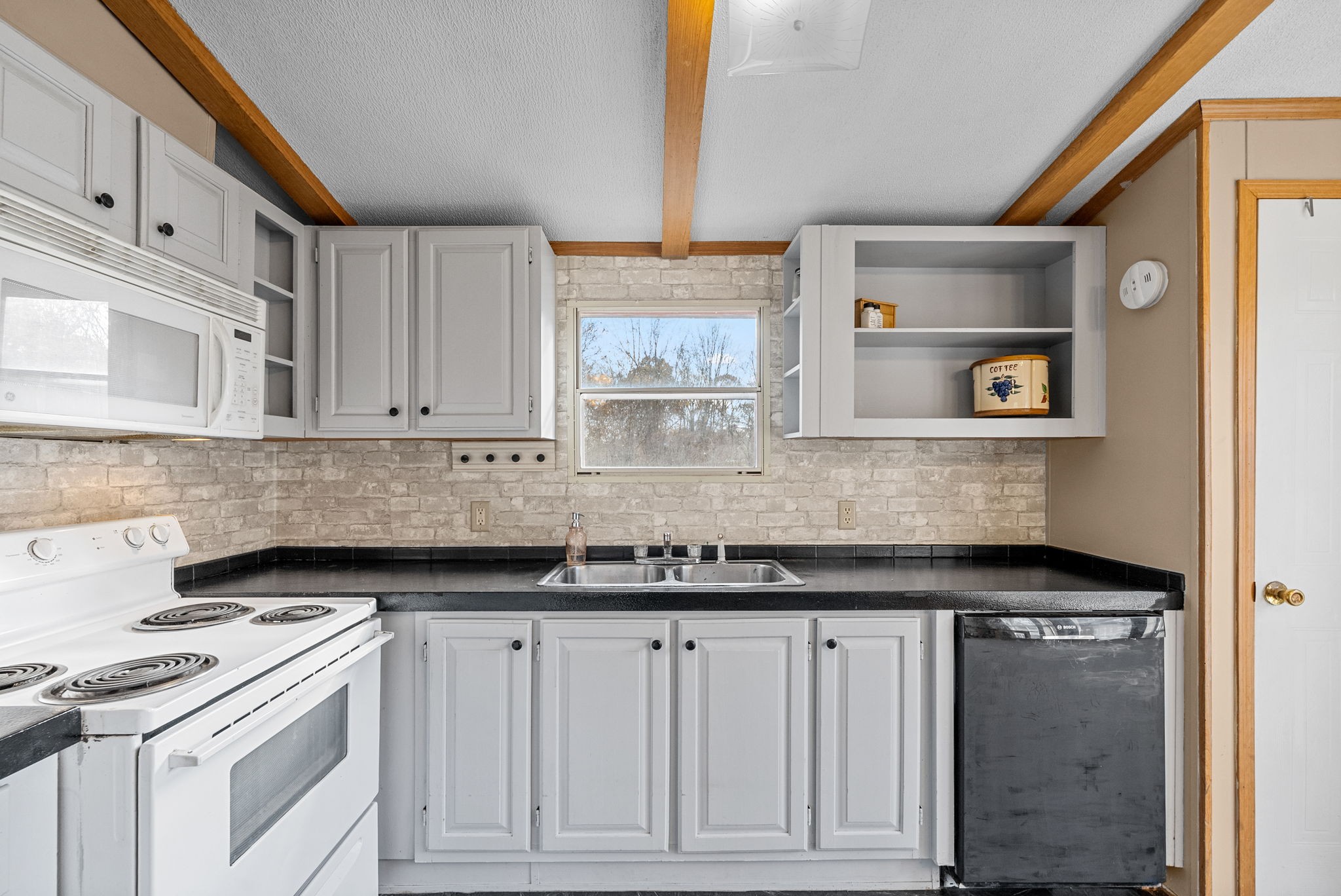 1196 Pickle Knight Road Joelton, TN 37080 - Photo 9 of 32 a kitchen with granite countertop a stove a sink and a microwave