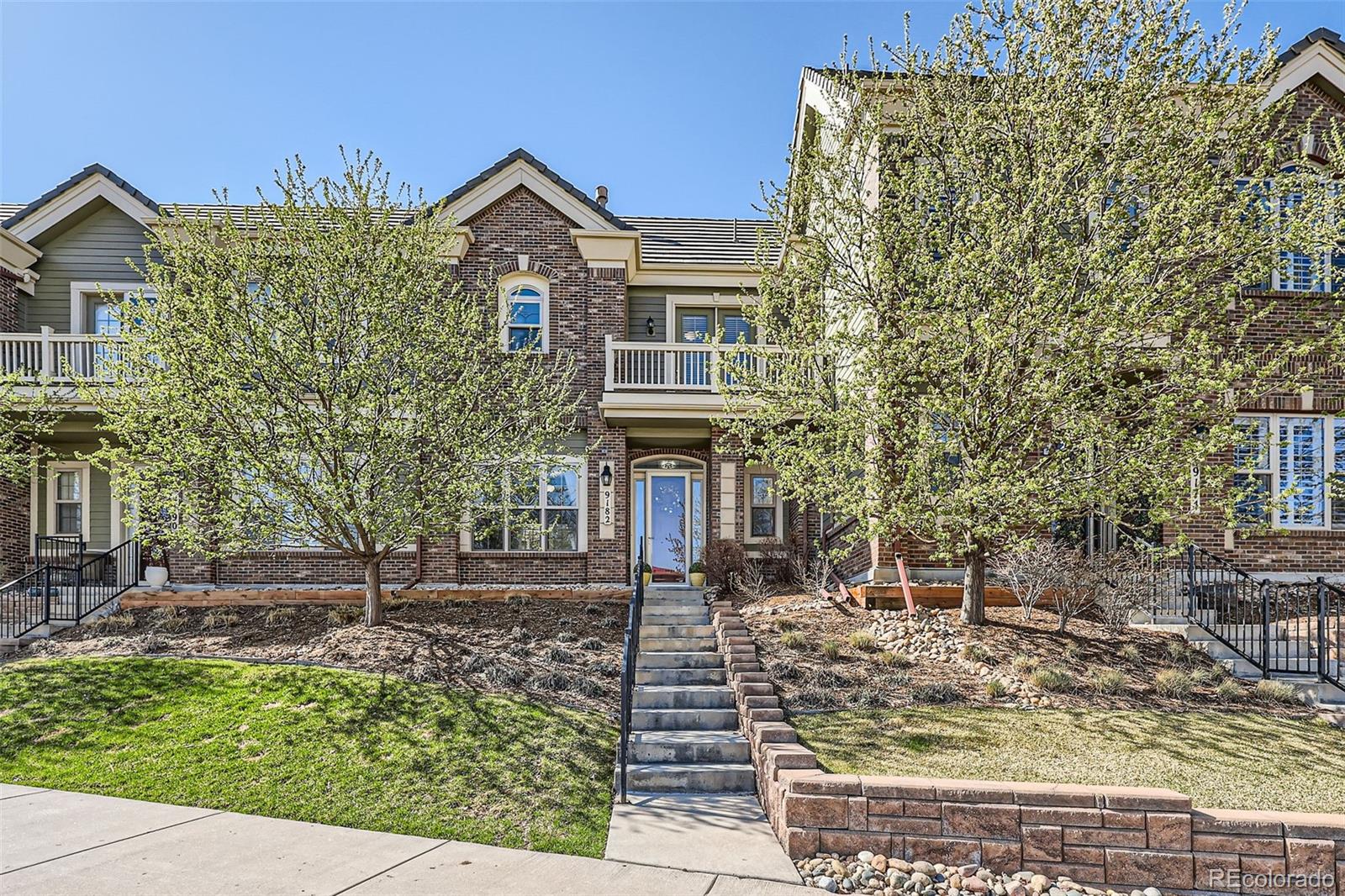 9182 Ridgegate Parkway Lone Tree, CO 80124 - Photo 1 of 31 a front view of a house with garden