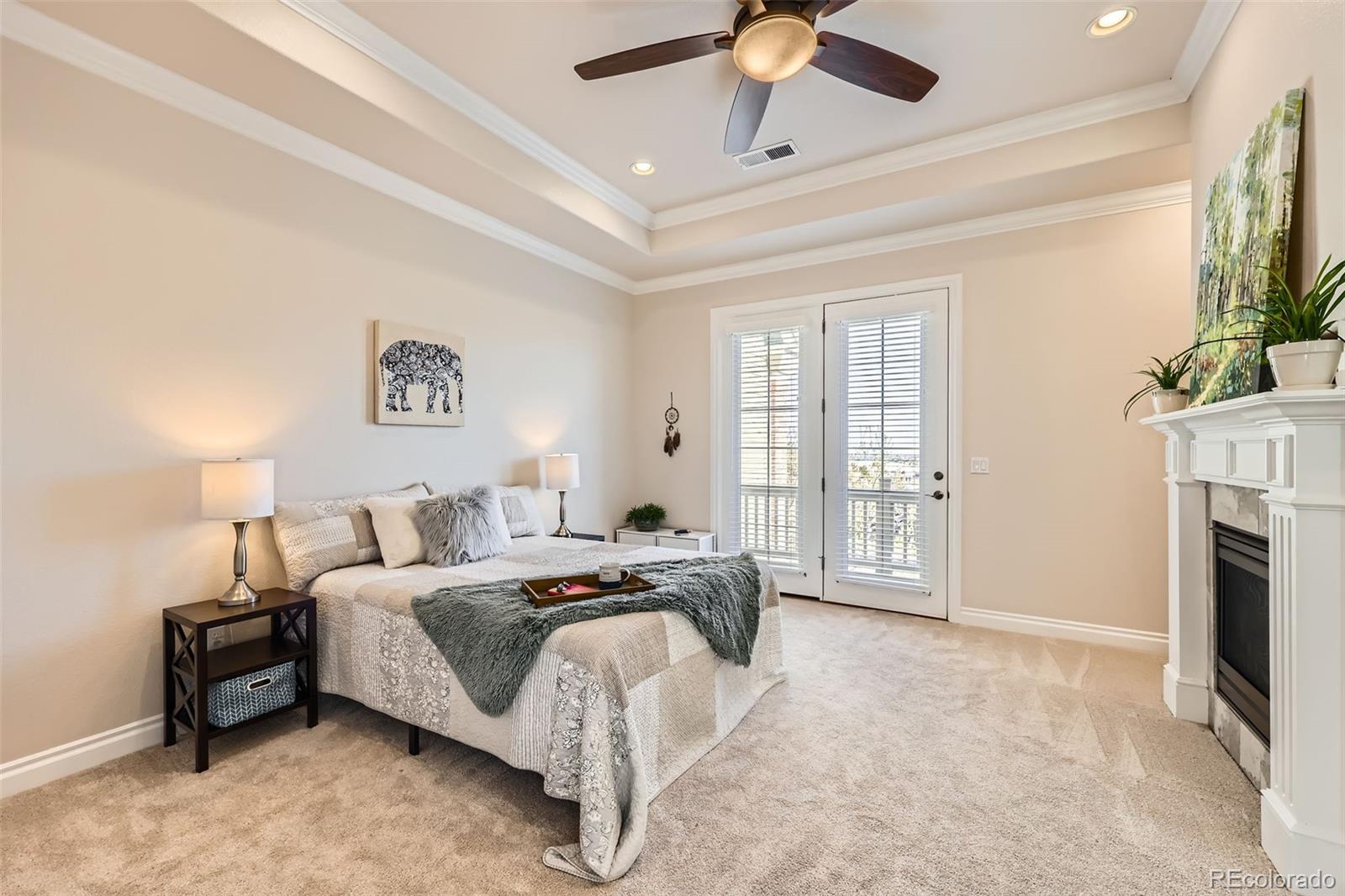 9182 Ridgegate Parkway Lone Tree, CO 80124 - Photo 13 of 31 a bedroom with a bed and a fireplace