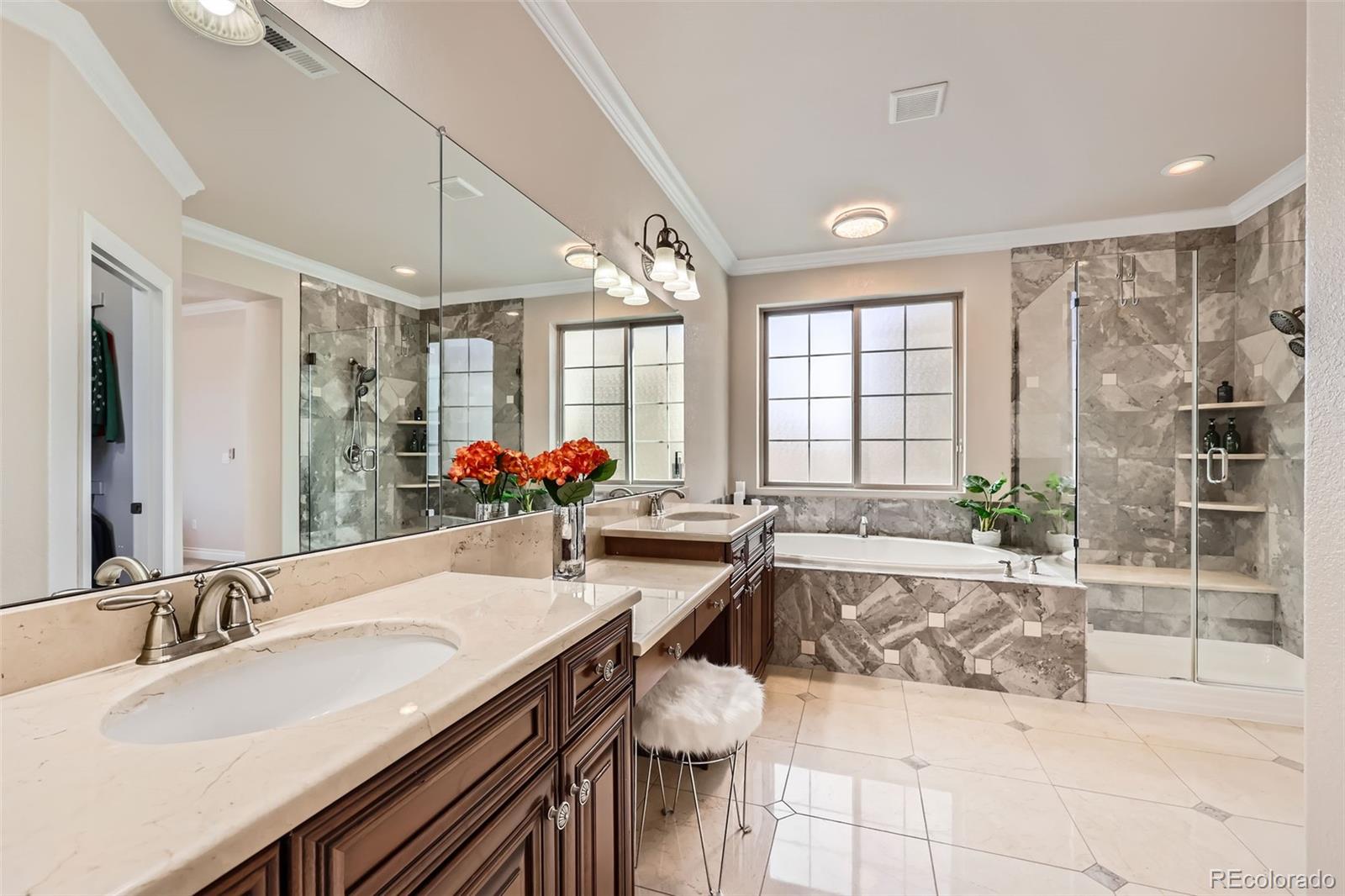 9182 Ridgegate Parkway Lone Tree, CO 80124 - Photo 16 of 31 a large bathroom with a tub sink and mirror