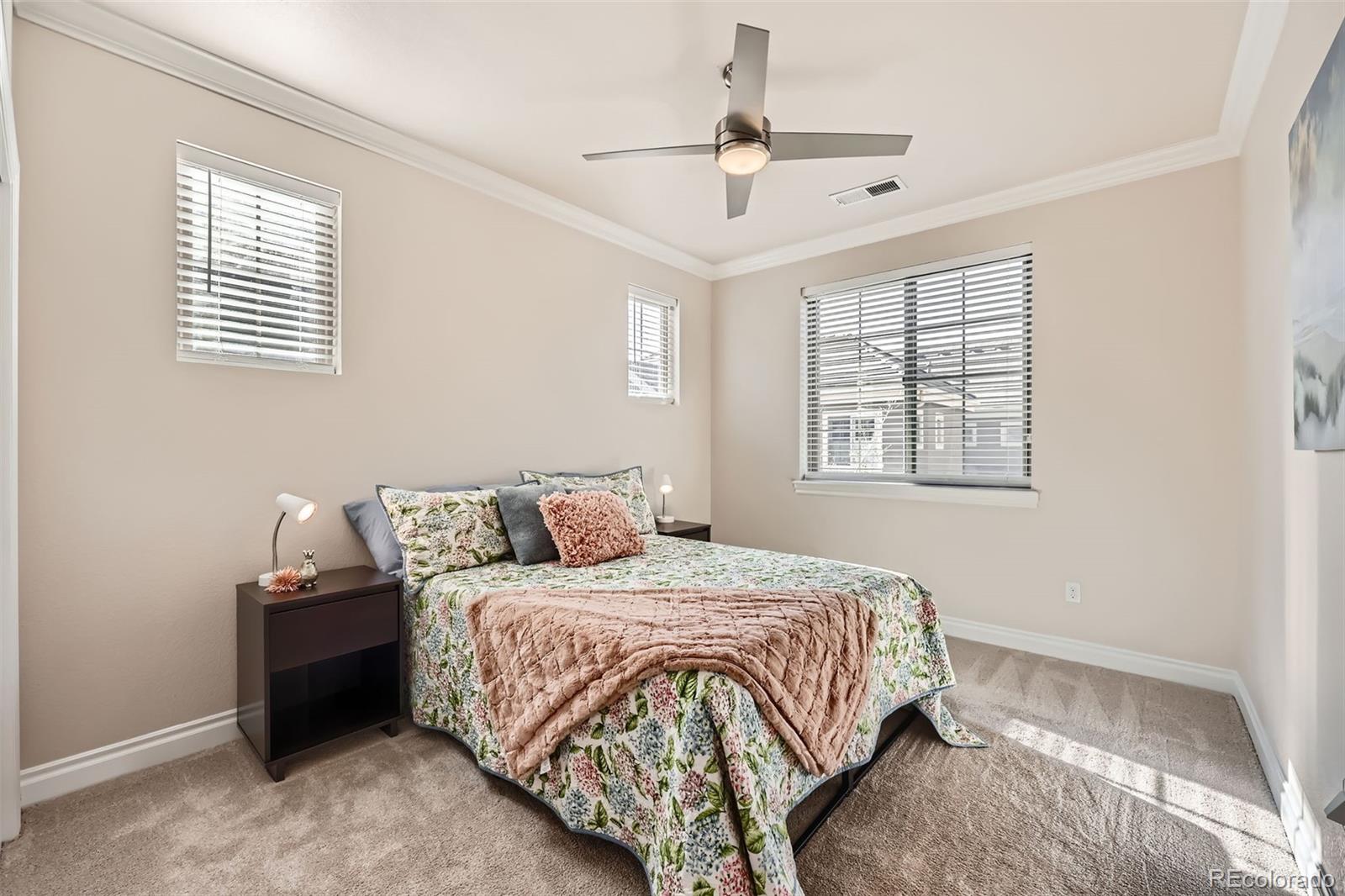 9182 Ridgegate Parkway Lone Tree, CO 80124 - Photo 18 of 31 a bedroom with a large bed and a window