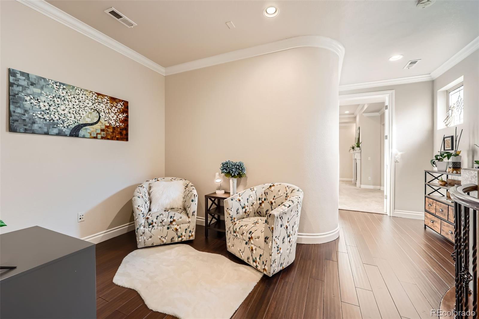 9182 Ridgegate Parkway Lone Tree, CO 80124 - Photo 22 of 31 a living room with furniture and wooden floor