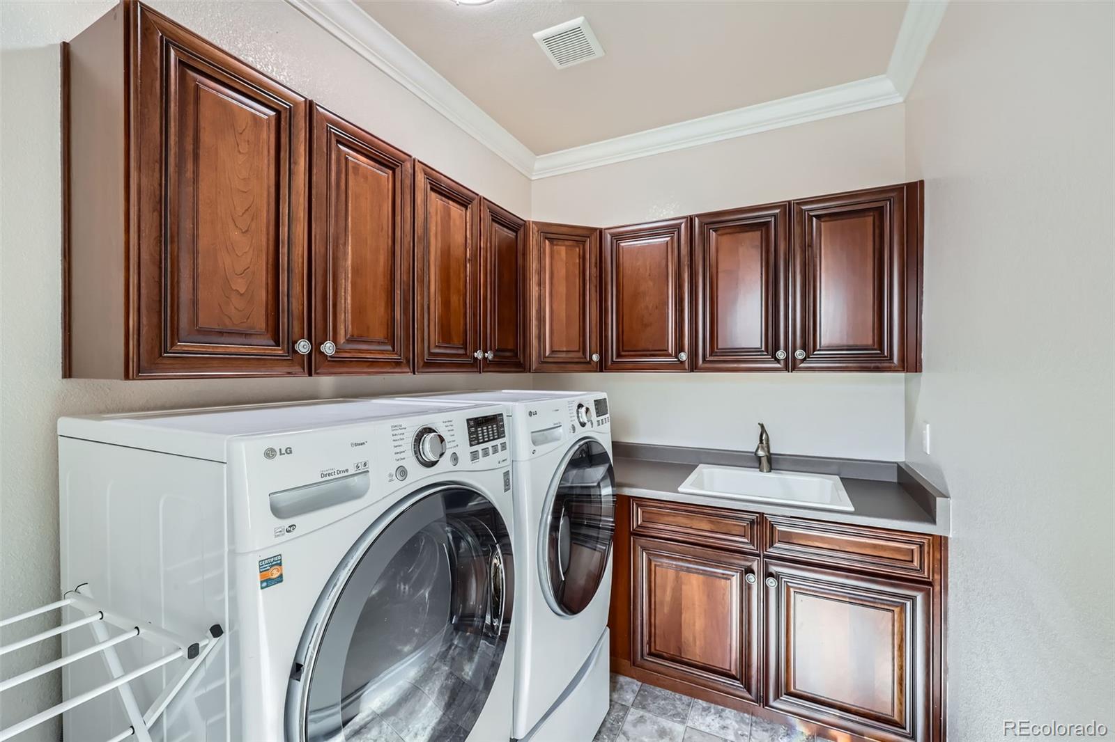 9182 Ridgegate Parkway Lone Tree, CO 80124 - Photo 23 of 31 a utility room with dryer and washer
